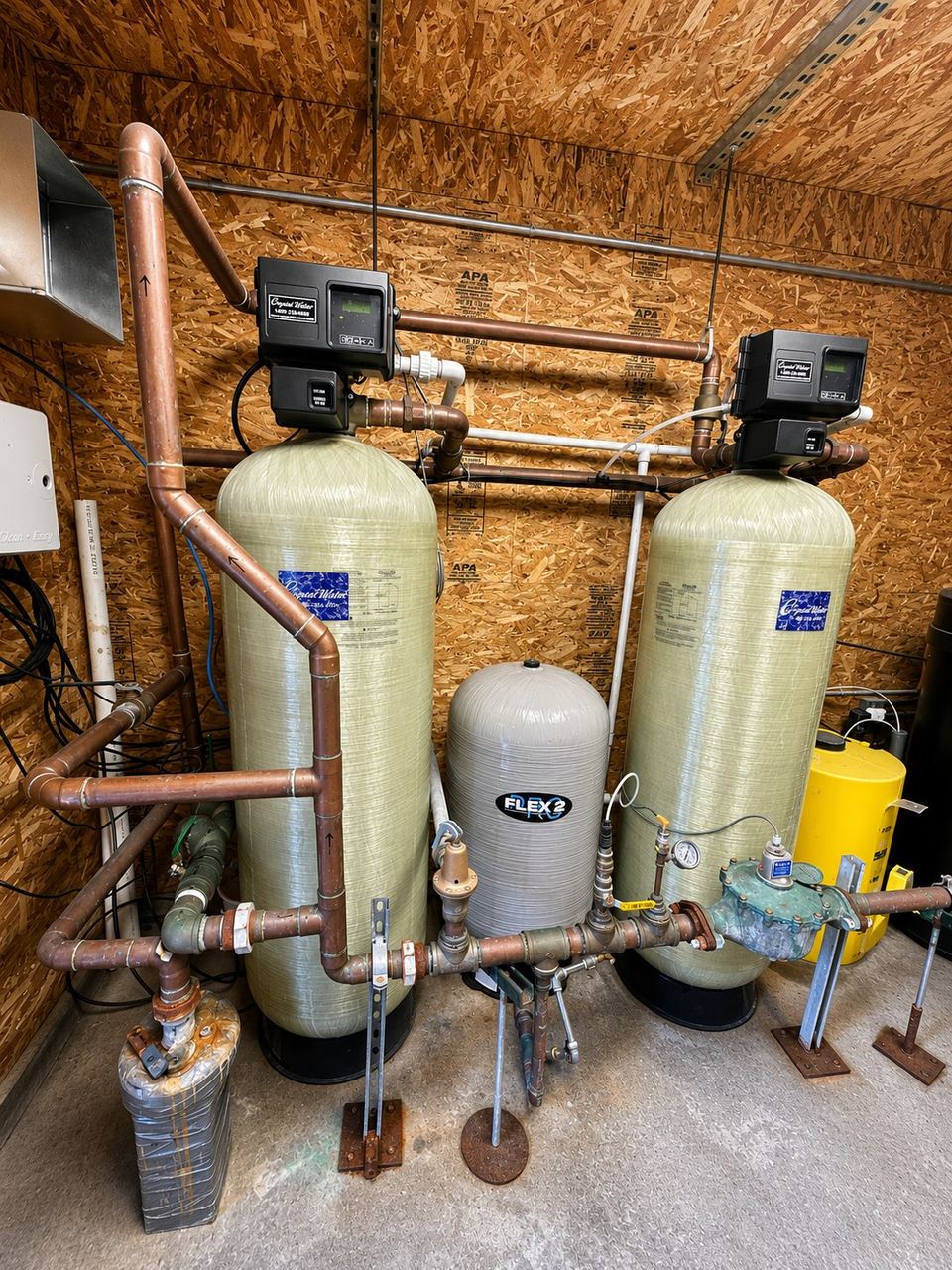 Pressure filtration tanks with copper piping in a treatment pump house