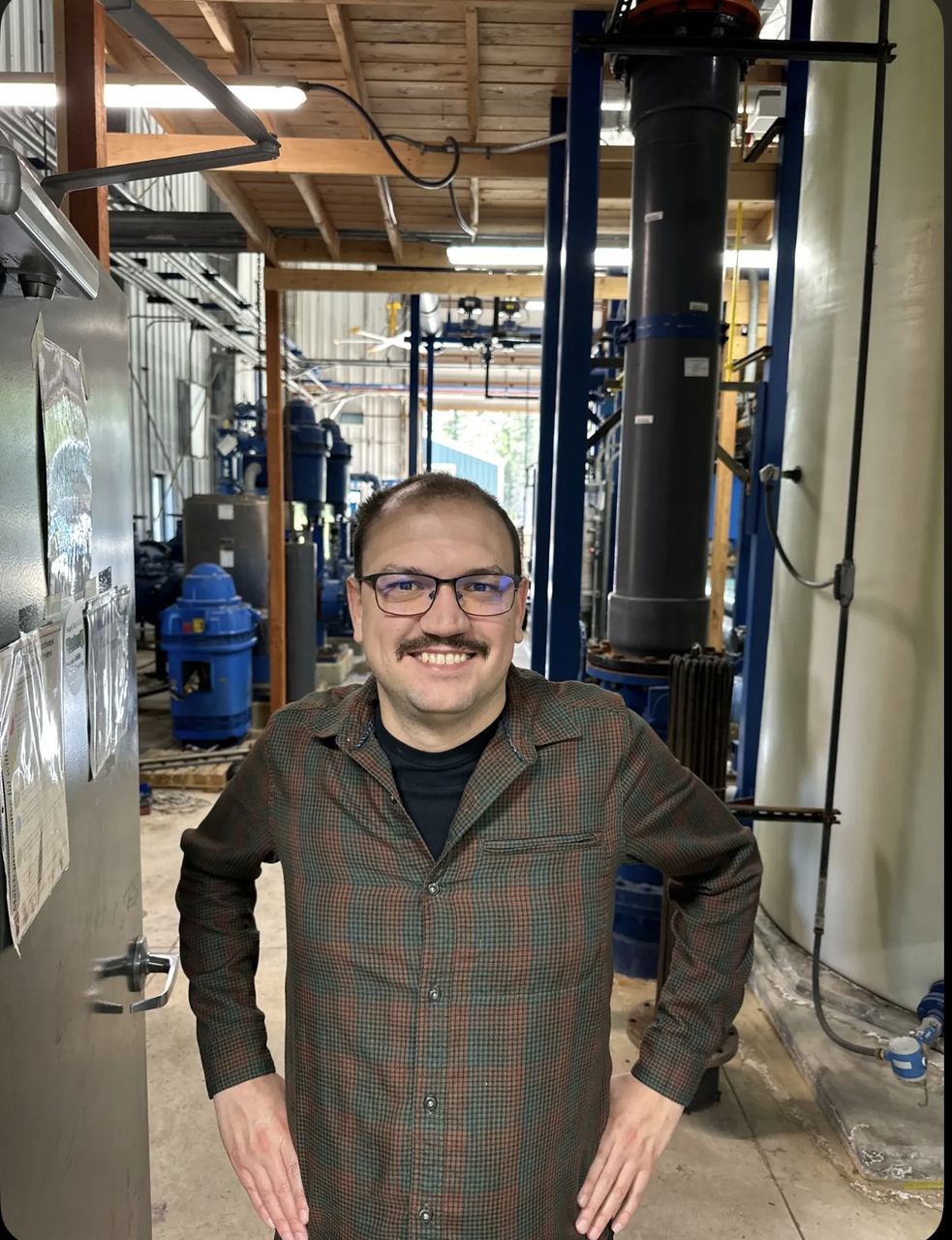 Water system operator standing inside a treatment plant