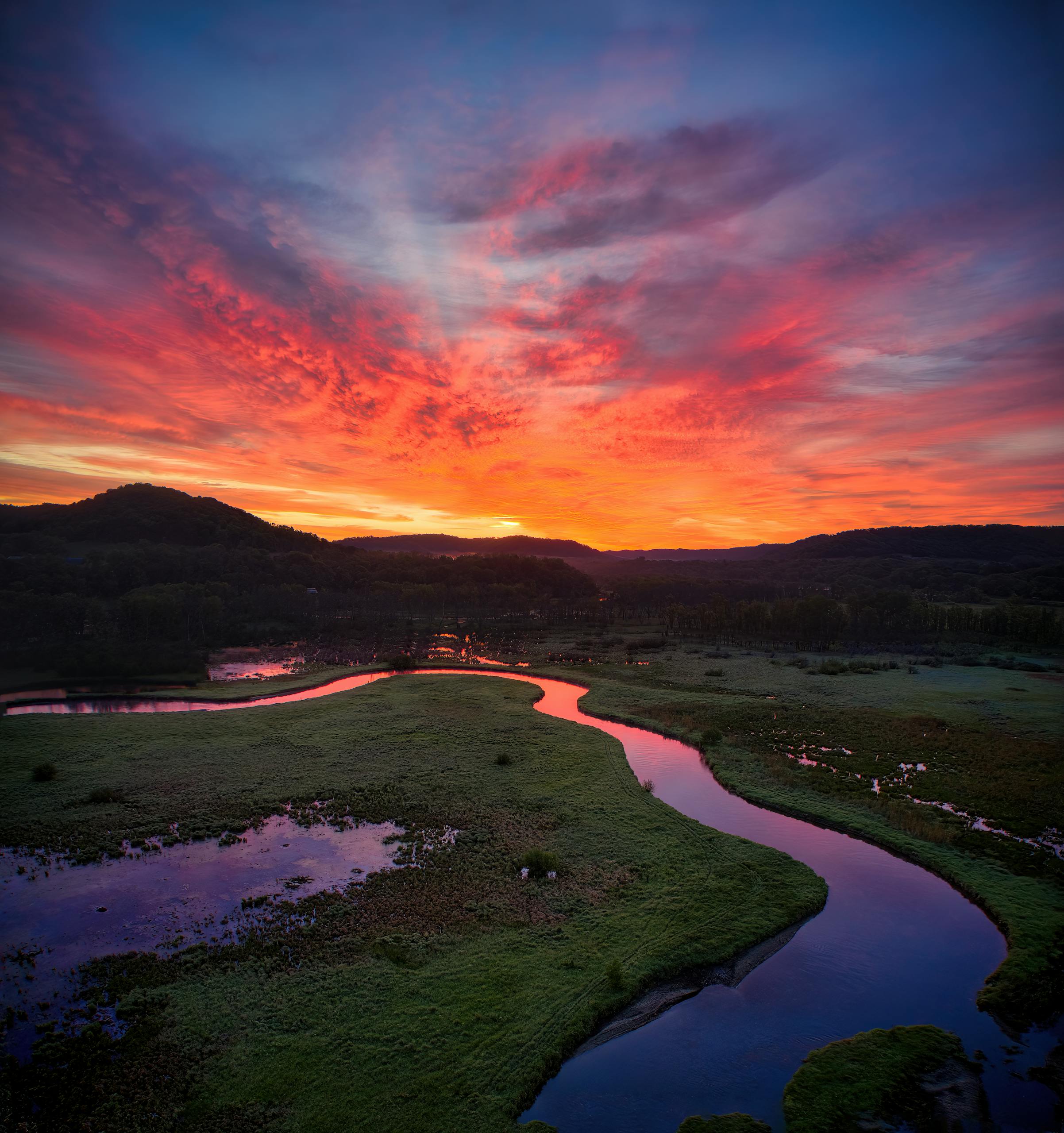 Sunset over a winding river in winter, representing cold-weather water system operations
