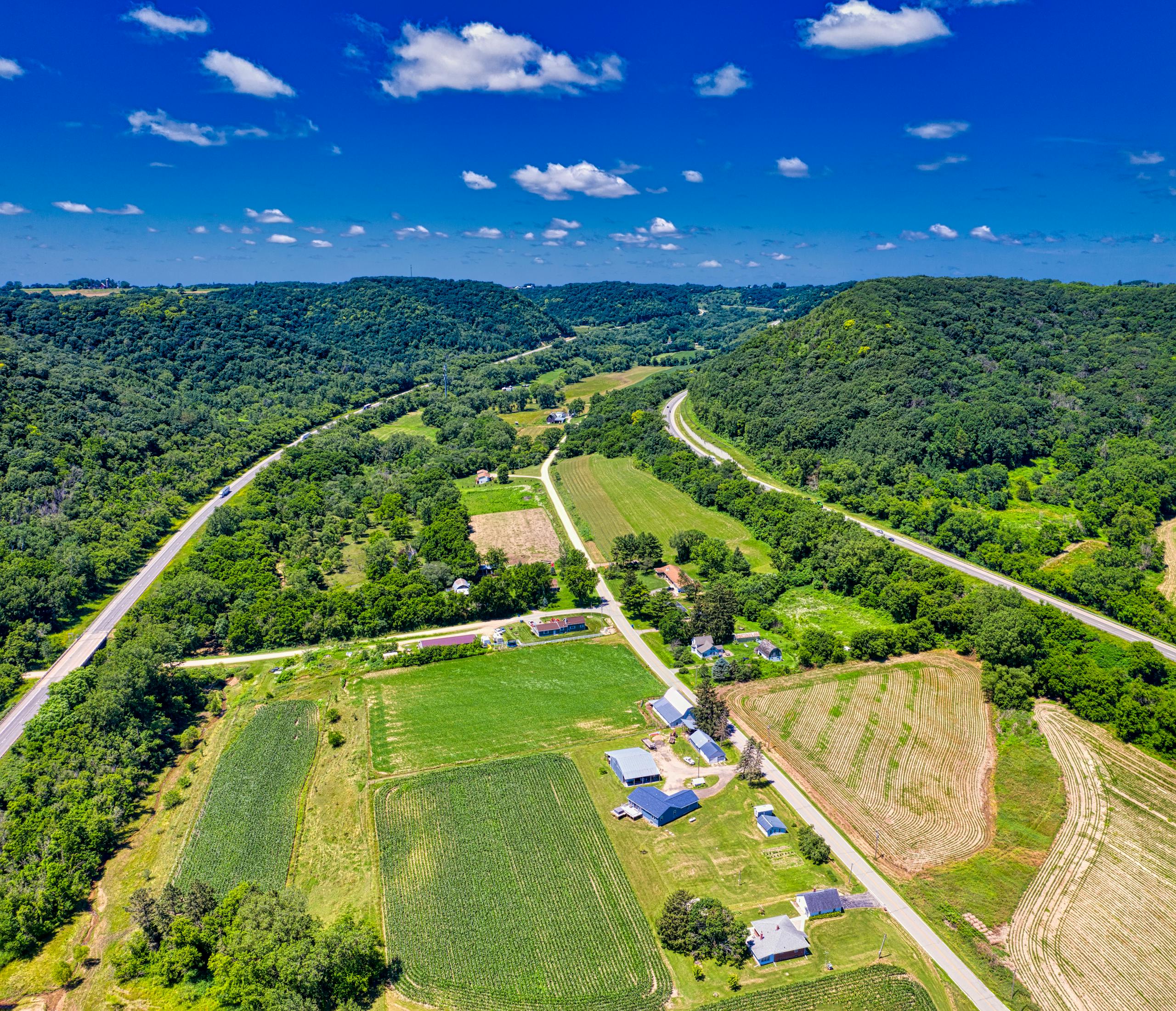 Aerial view of lush farmland and rolling hills in Dakota, Minnesota where rural water systems operate